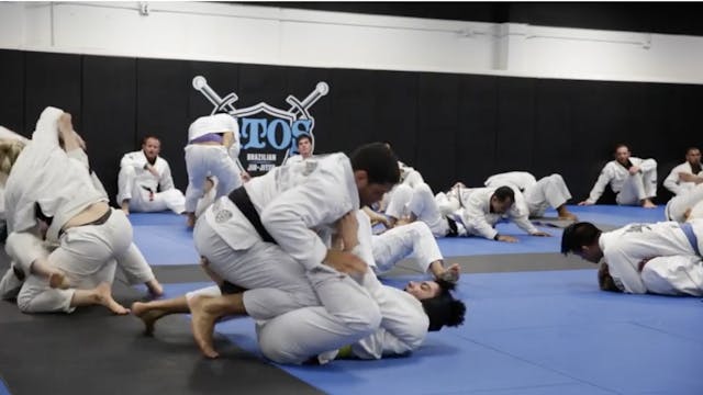 Andre Galvao rolling with a yellow belt