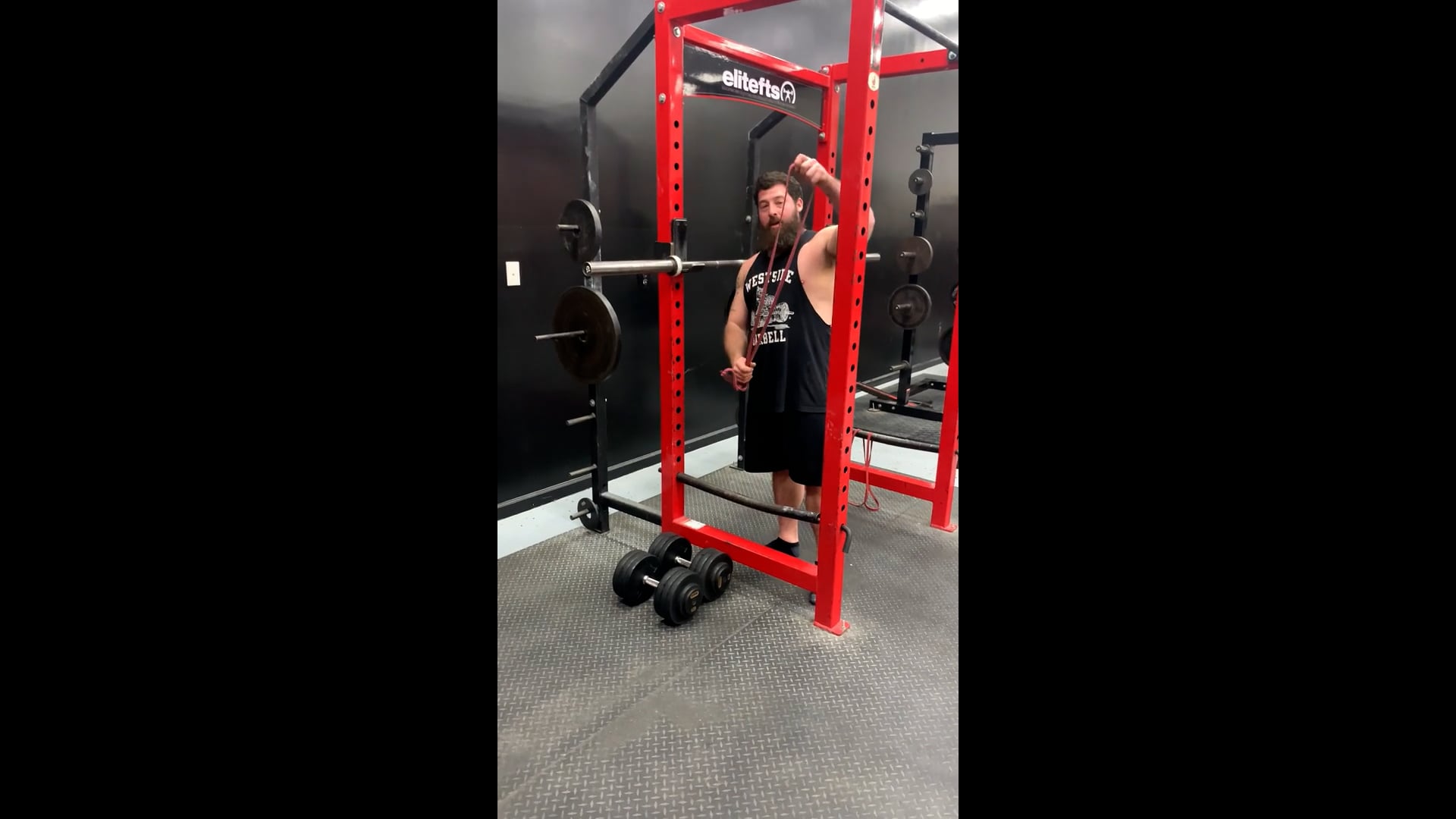 Banded Squat Setup in Power Rack With Dbs