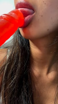 Sucking on a candy lollipop!