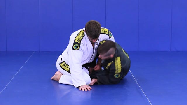 Trap arm roll under from butterfly guard