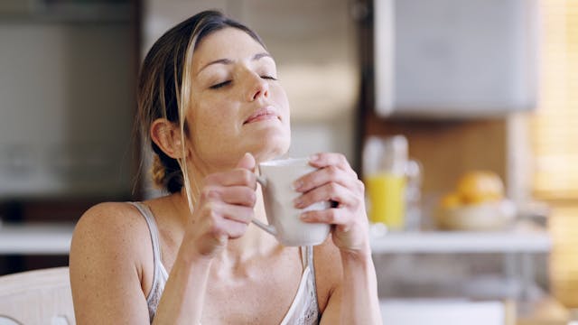 Smiling Worker Coughs in Hand
