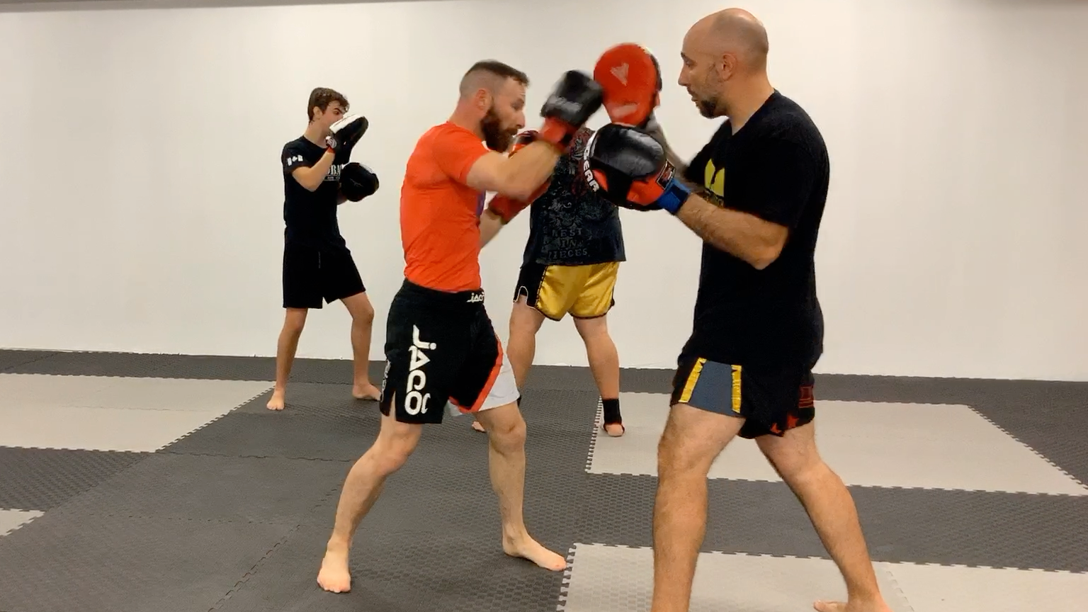 Muay Thai Fundamentals White Shorts:1st Stripe/lesson 5 Focus Mitt holding