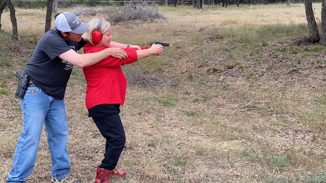Lady in red on the shooting range