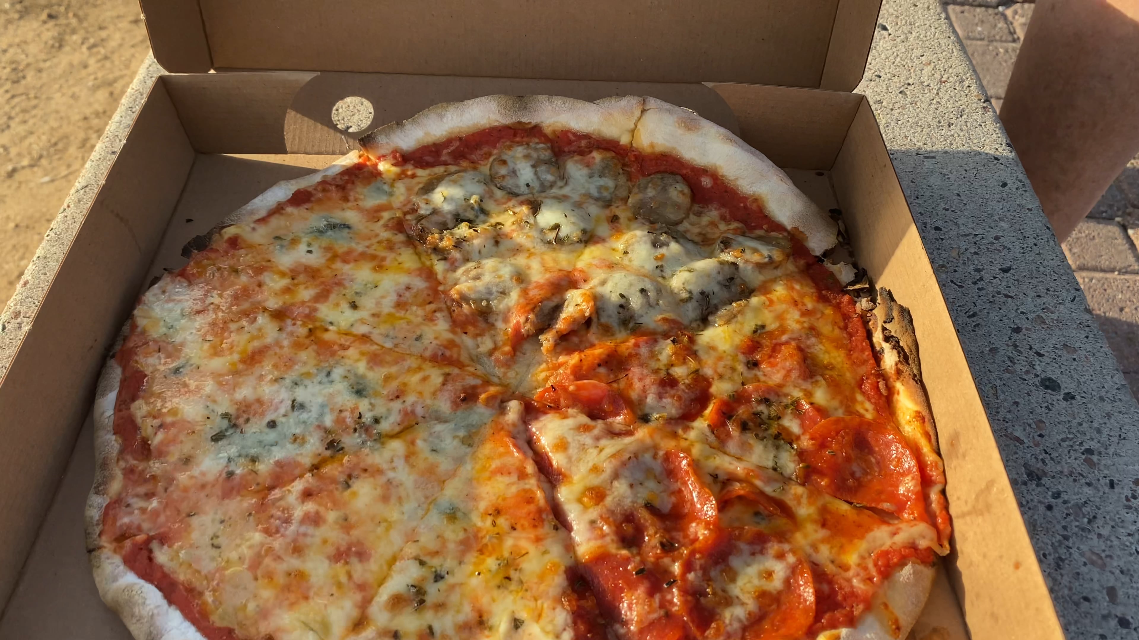 Pizza with pepperoni, sausage and Tre formaggi