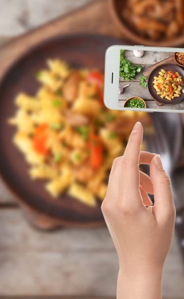 Why do people take and share photos of their meals?