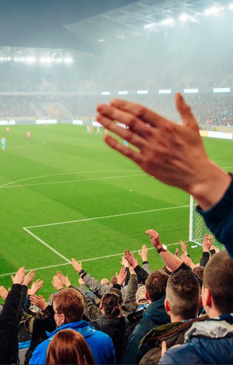 Why do people sing songs at football matches?