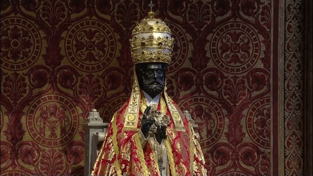 Why is St. Peter's statue dressed in papal vestments?
