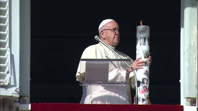 Pope lights one of thousands of candl...
