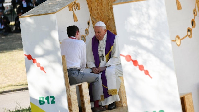 Pope Francis hears confessions from youth in confessionals made by prisoners