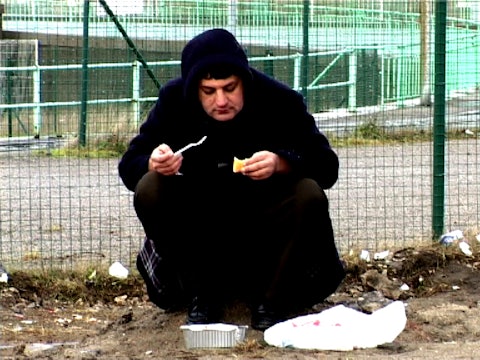 Calais Still - Ijaz eating bread