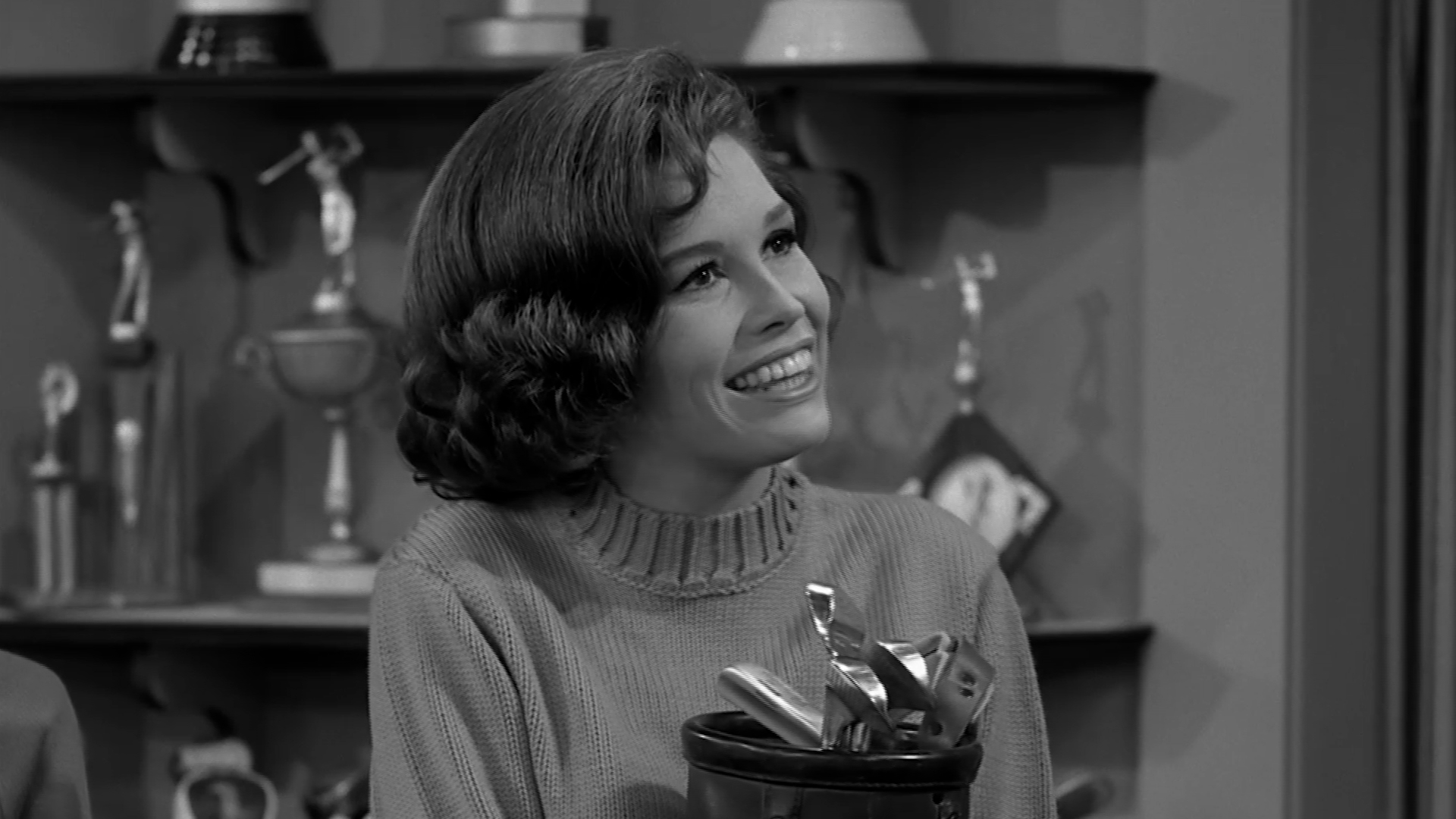 Laura meets her old love and discovers he has entered the priesthood.