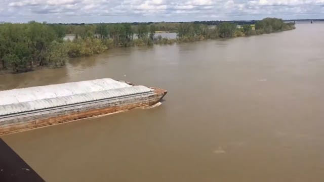 An aerial time-lapse of a towboat and...