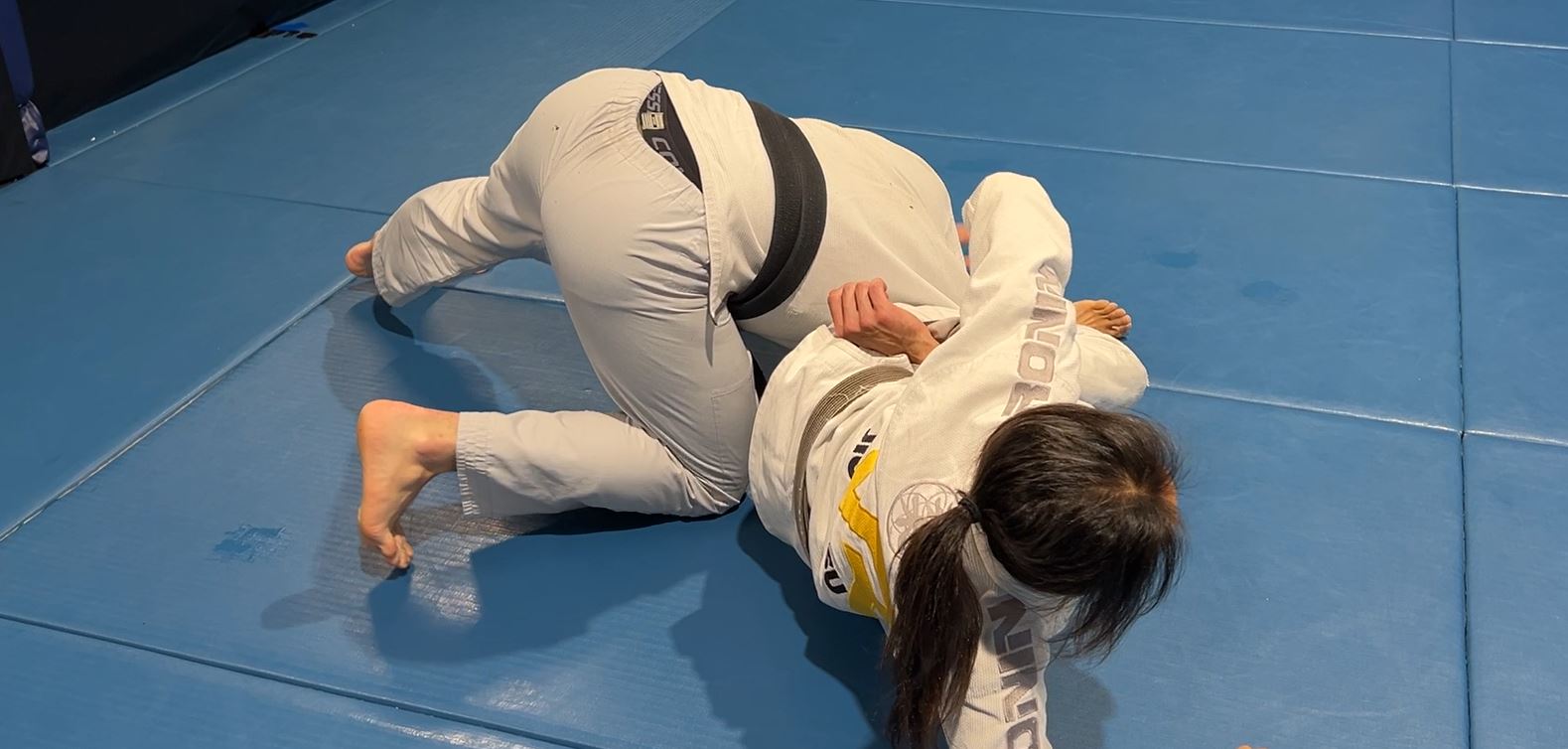 Guard Pull to Omoplata using collar and sleeve grips 