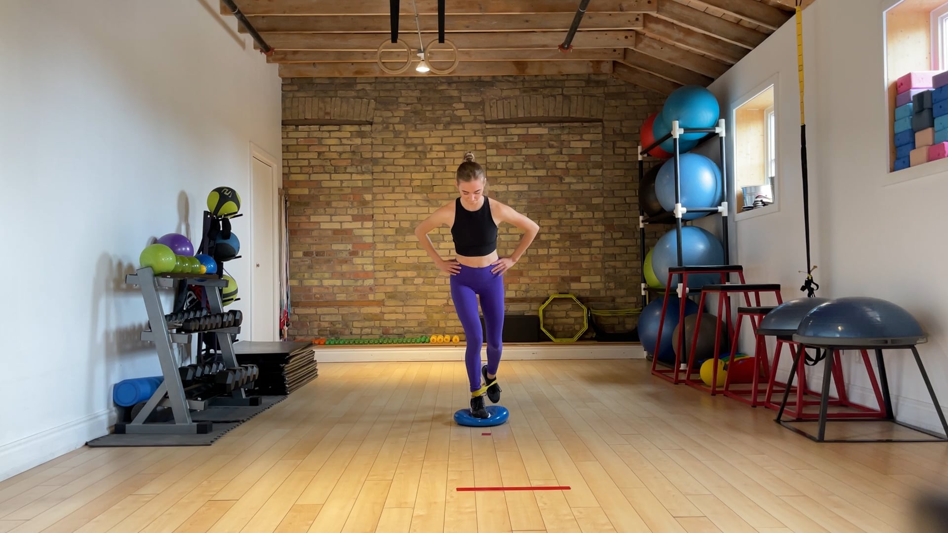 Elite: Off-ice single leg banded reach back on wobble disc drill