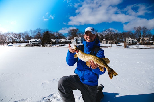 Premium Photo  Winter fishing for pike on the imitation fish on the frozen  lake small tackle for winter fishing on the ice pond reeling reel for a  fish in the ice
